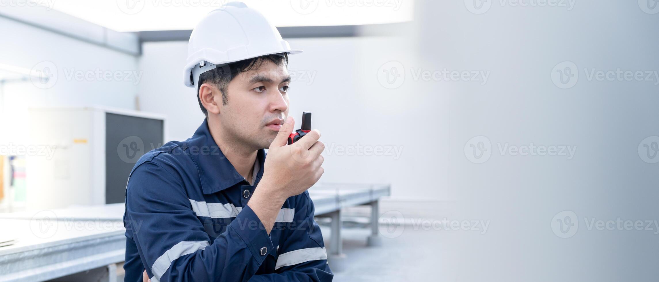 Asian maintenance engineer working on color background, contractor inspect compressor system and plans installation of air condition systems in construction. technology, walky talky, maintenance photo