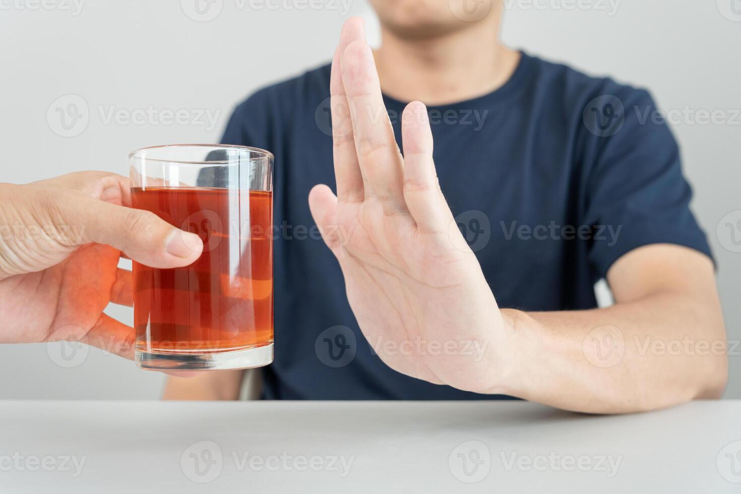 man refuses say no and avoid to drink an alcohol whiskey , stopping hand sign male, alcoholism treatment, alcohol addiction, quit booze, Stop Drinking Alcohol. Refuse Glass liquor, unhealthy, reject photo