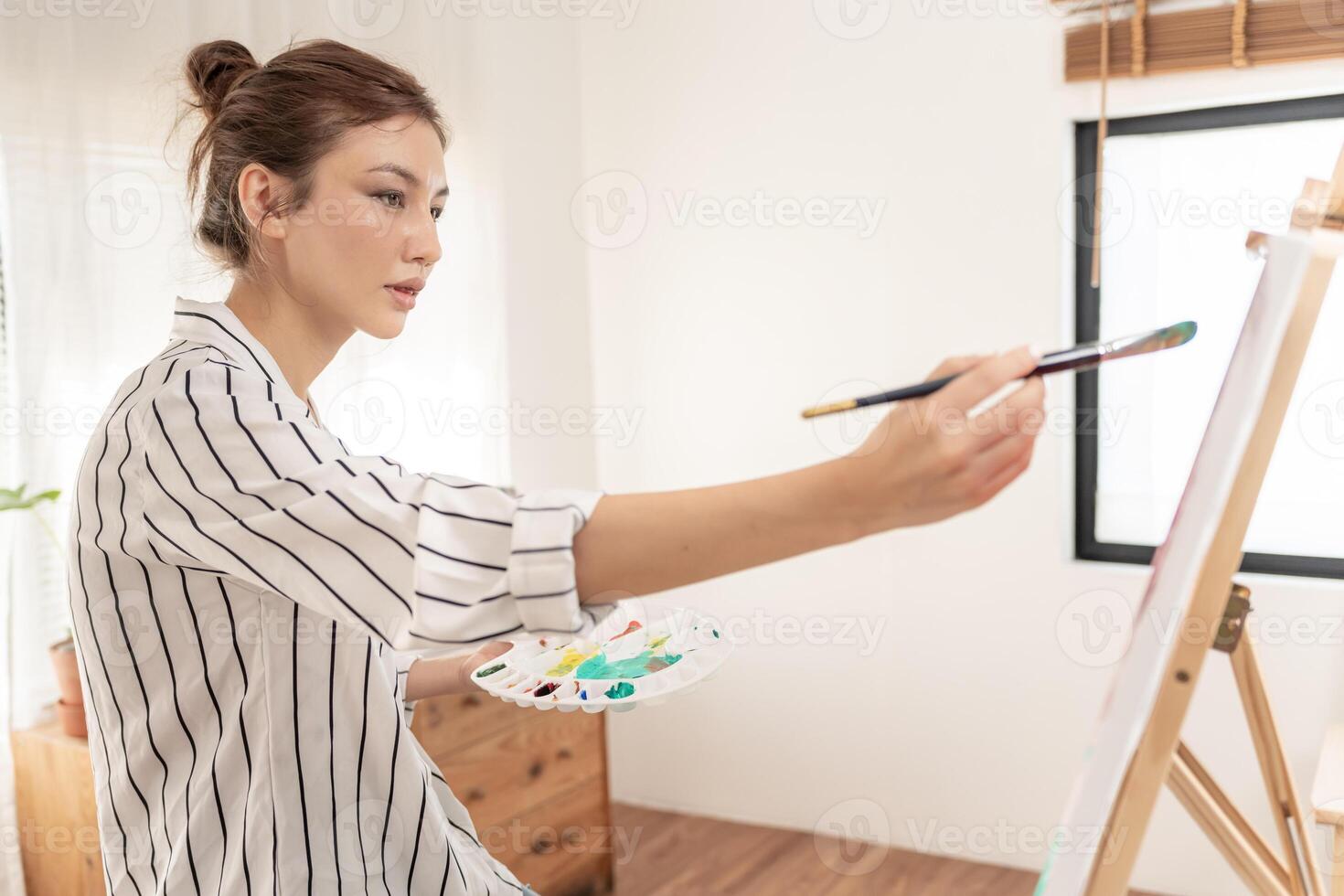 female hobbies about artist and use paintbrush in abstract art for create masterpiece. painter paint with watercolors or oil in studio house. enjoy painting as hobby, recreation, inspiration photo
