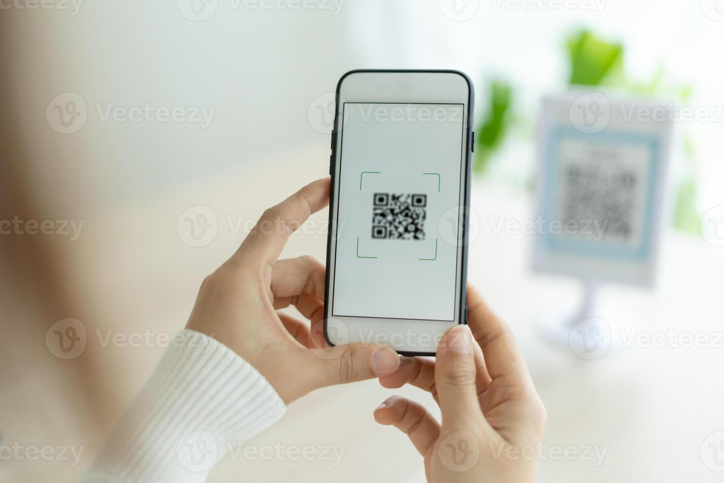 Modern woman use phone to scan barcode or QR codes to pay credit card bill after receive document invoice. payment, receive, paying electricity, digital payments without money, technology, scanning photo