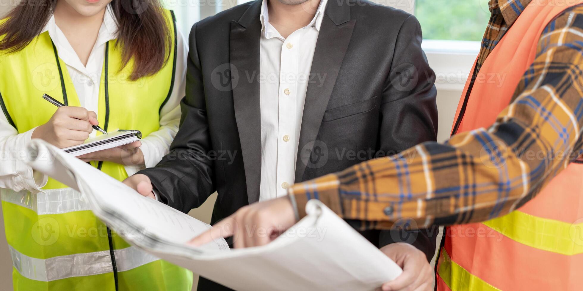 Engineers team discuss check and review the blueprint of construction. Contractor inspection drawing before start project civil. project planning, consulting, architecture photo