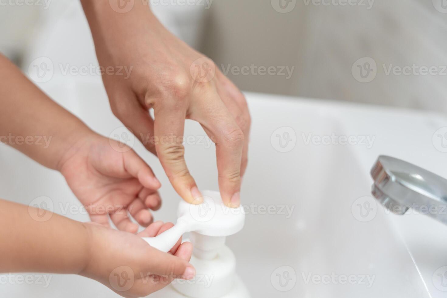 little kid hands wash with soap bubbles and rinse with clean water to prevent and stop the spread of germs after back to home, virus or covid19. Good health and good personal hygiene, virus, bacteria photo
