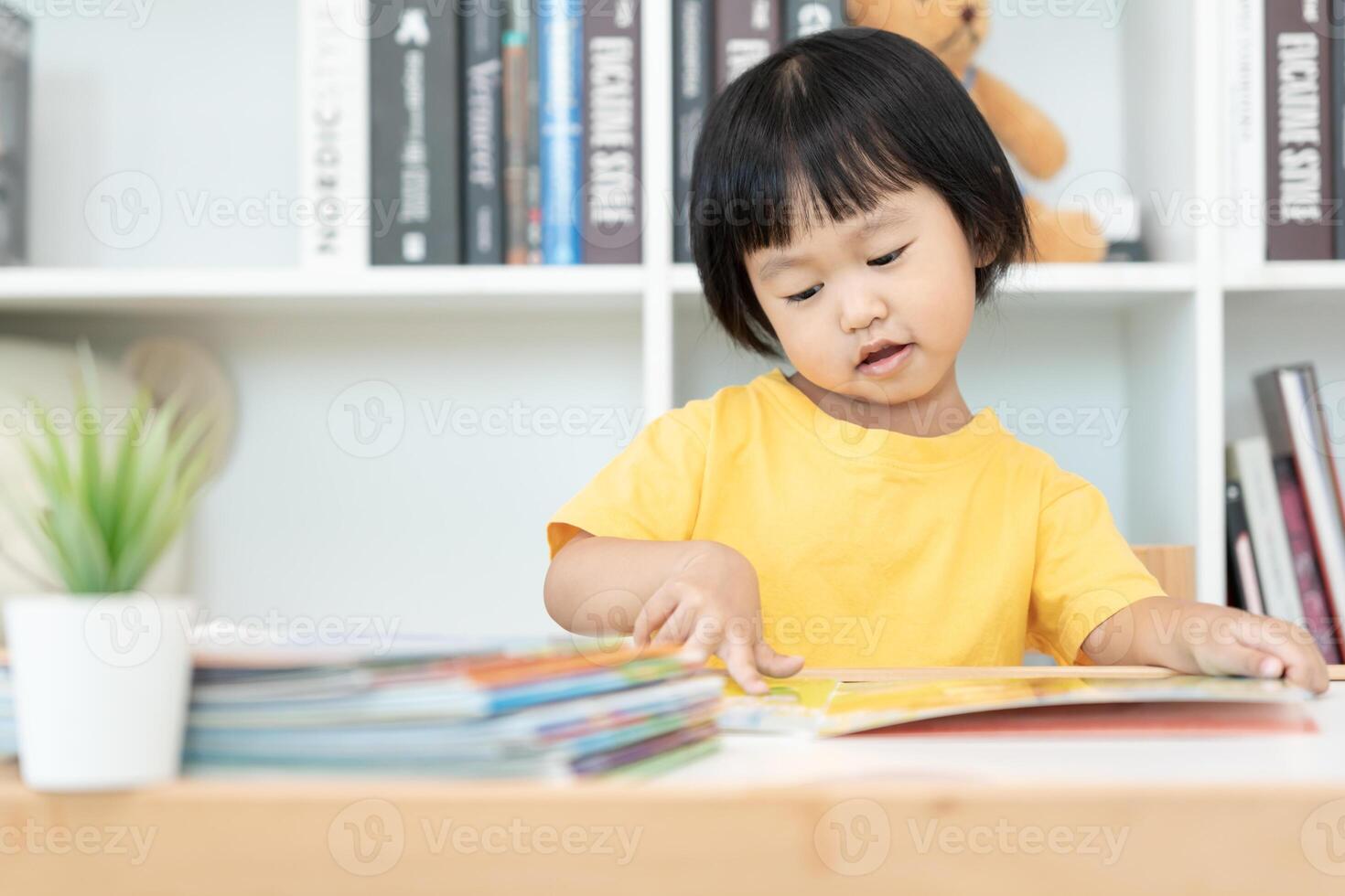 Happy Asian children relax read book at home. daughter and reading a story. learn development, childcare, laughing, education, storytelling, practice, imagine, reduce addiction mobile phone photo