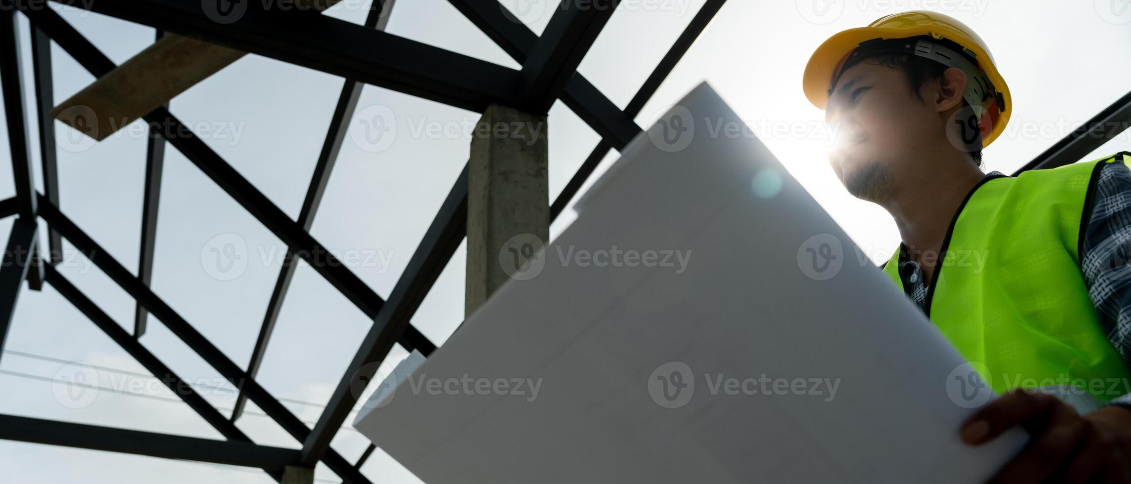 inspector or engineer is inspecting construction and quality assurance new house using a blue print. Engineer or architects or contactor work to build the house before handing it over to the homeowner photo