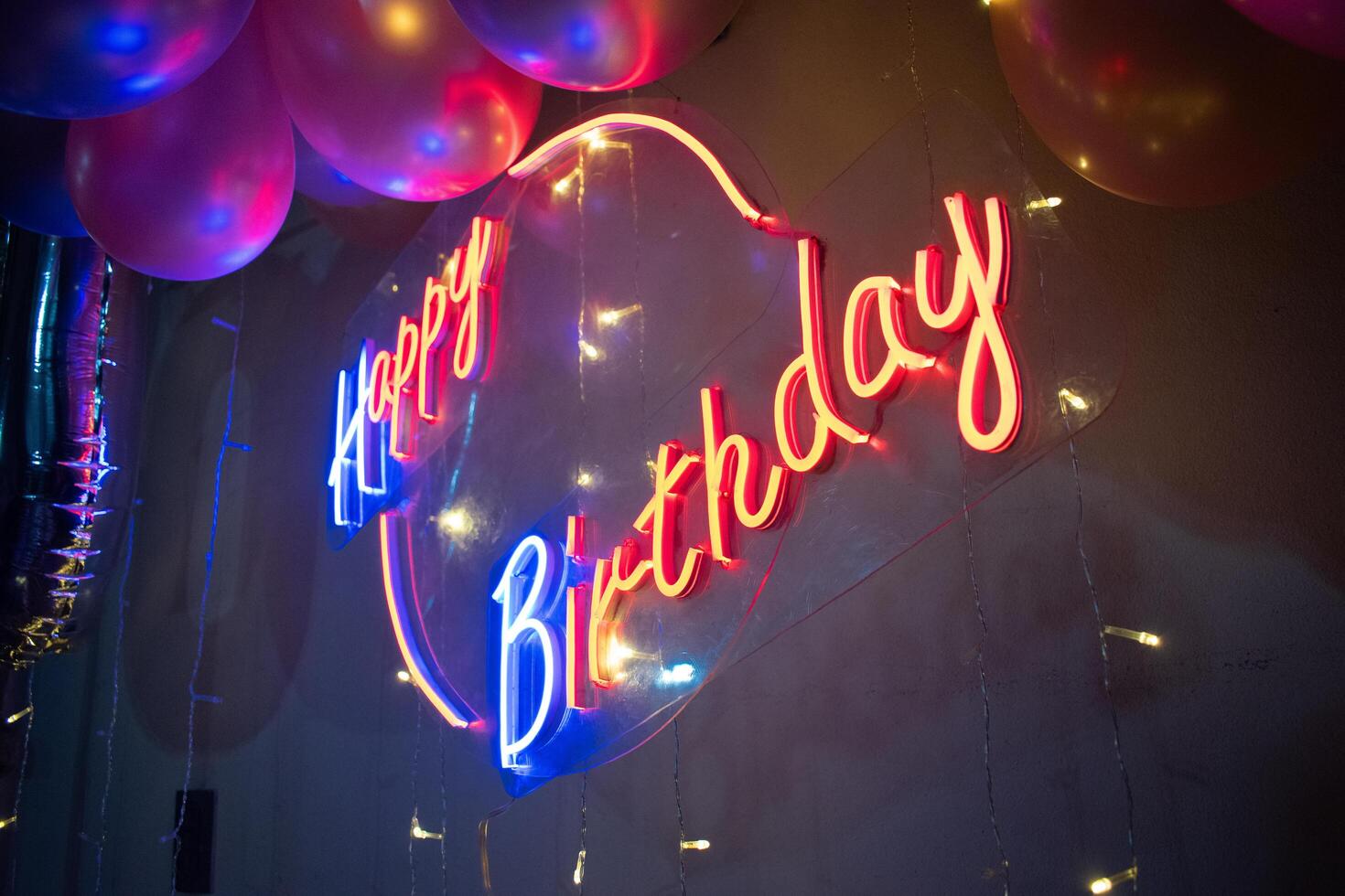 Birthfday party with balloons and a shiny led sign to celebrate another year of life photo