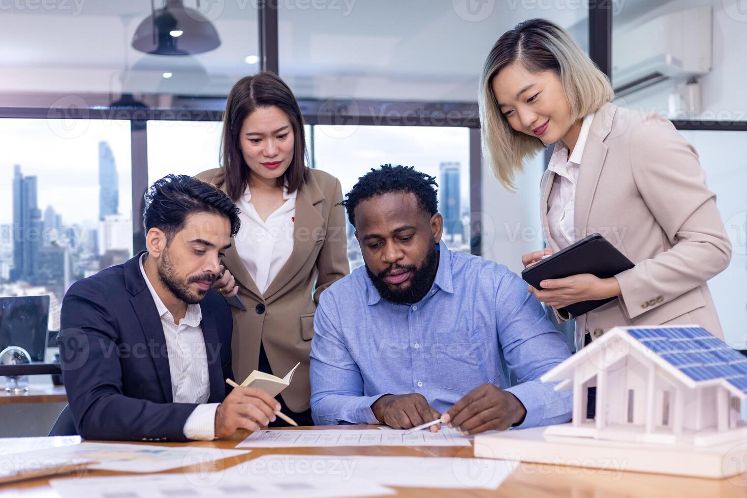 Team of architectures and engineers are discussing and brainstorming on floor plan over clean energy and power saving house design using solar panel for green industry and futuristic home development photo