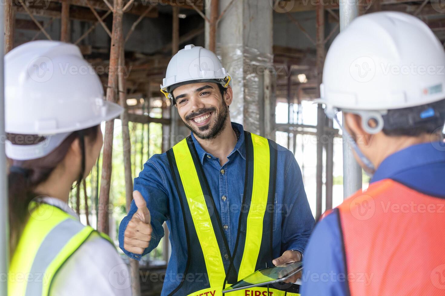 Engineering manager is giving thumbs up to contractor and foreman in meeting and consulting at construction building site for inspection in real estate development project industry and quality control photo