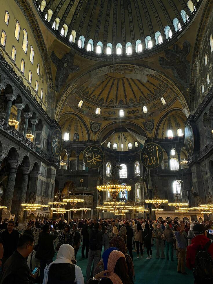 17 de abril 2023 - Estanbul, Turquía - interior decoración de hagia Sofía, hermosa candelabros, frescos y turistas foto
