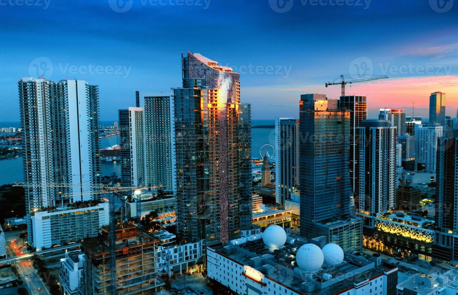 Aerial View of Miami City at Night From Building Top. Capture the breathtaking view of Miamis illuminated cityscape under the night sky from the top of a building. photo