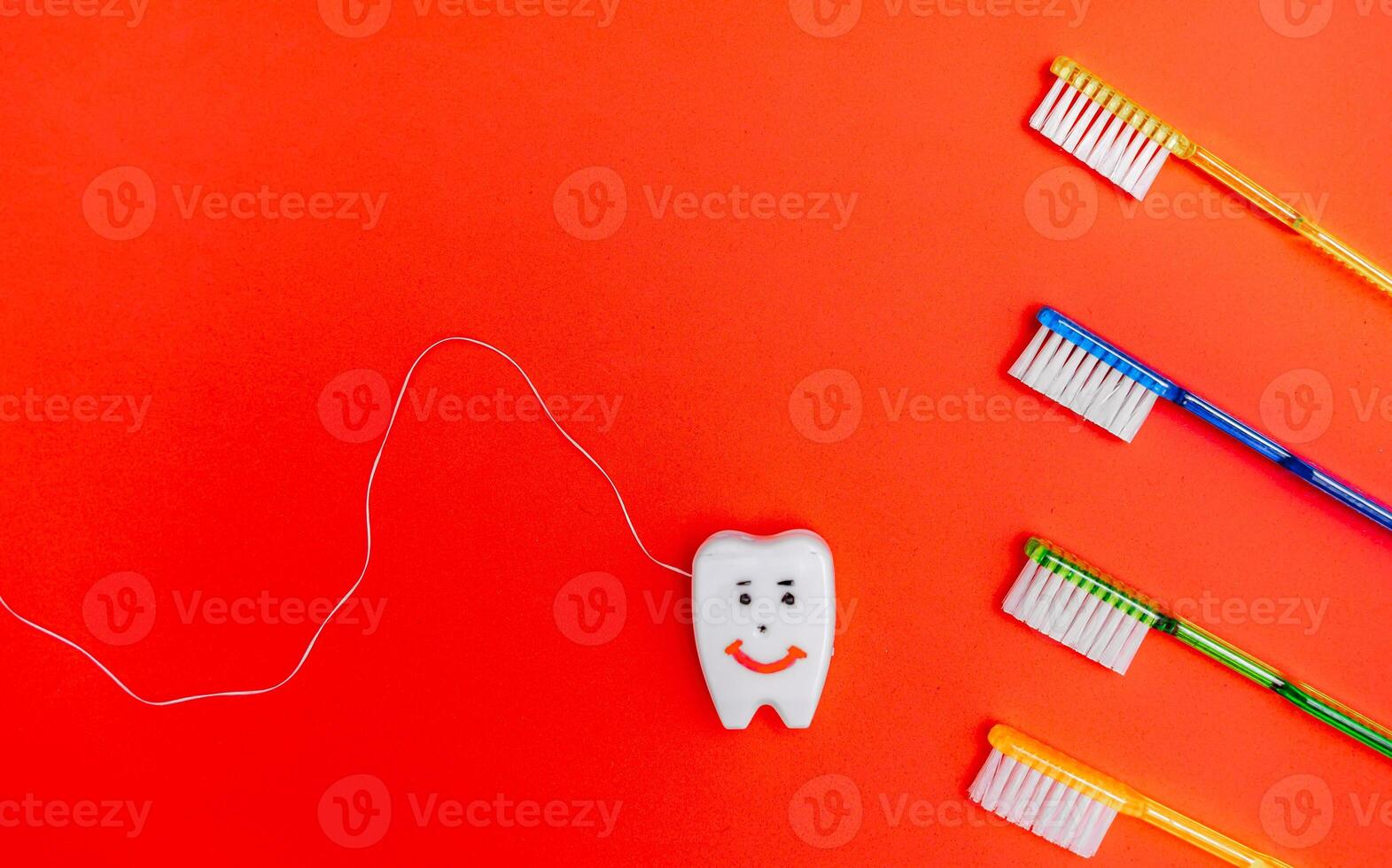 Toothbrushes and Toothpaste on a Red Background photo