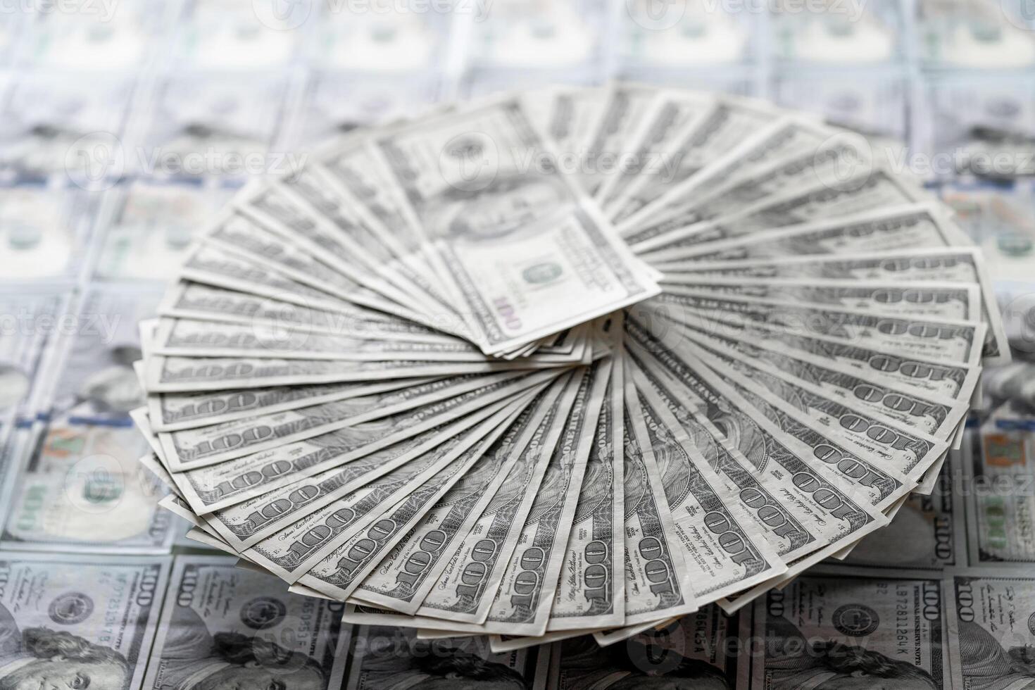 Stack of Twenty Dollar Bills on Top of a Pile of Twenty Dollar Bills. A stack of twenty dollar bills placed on top of a larger pile of twenty dollar bills. photo