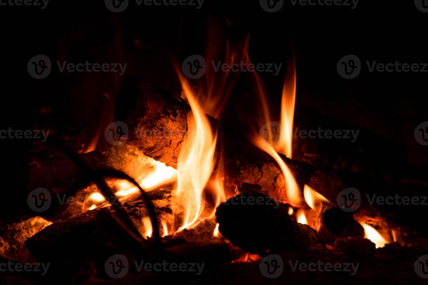 a fire burning in a fireplace with logs photo