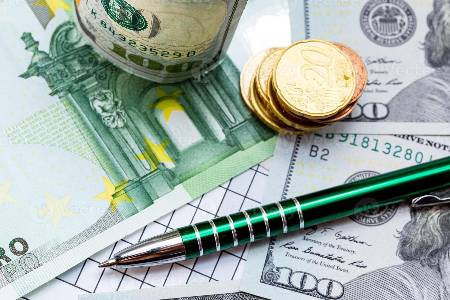 A Table with a Pen and Money. A pen and some money on a table photo