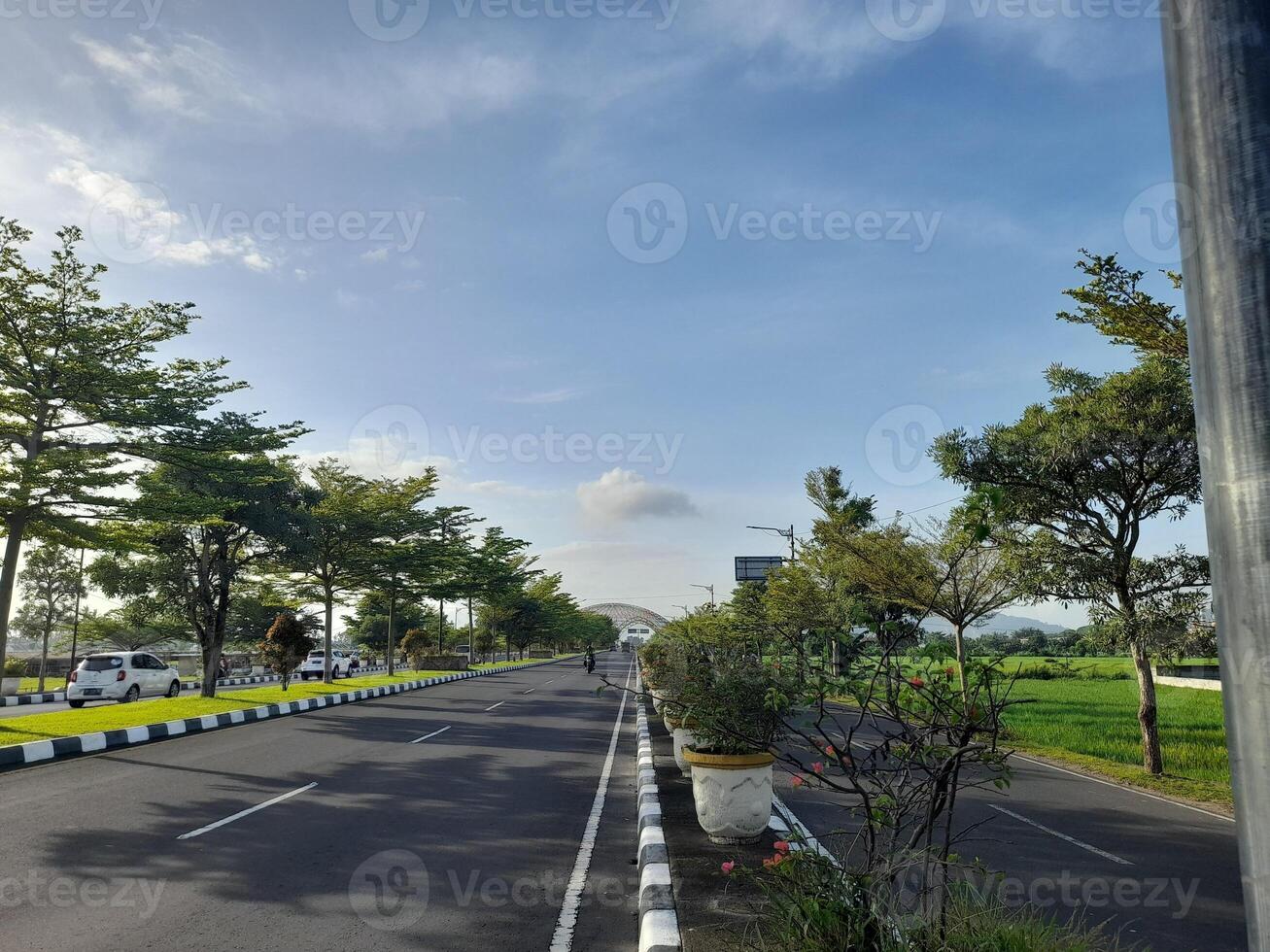 A view of the road, trees and sky on Lombok Island, Indonesia photo
