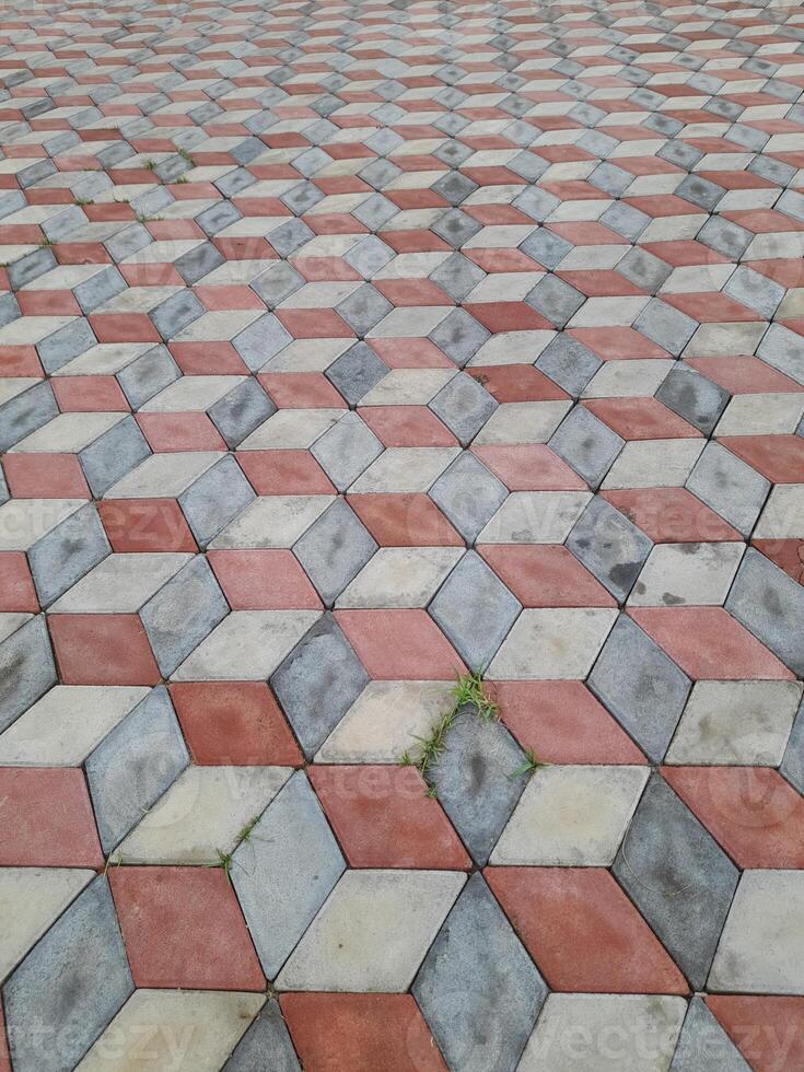 paving slabs in the form of volumetric cubes of gray and terracotta color photo