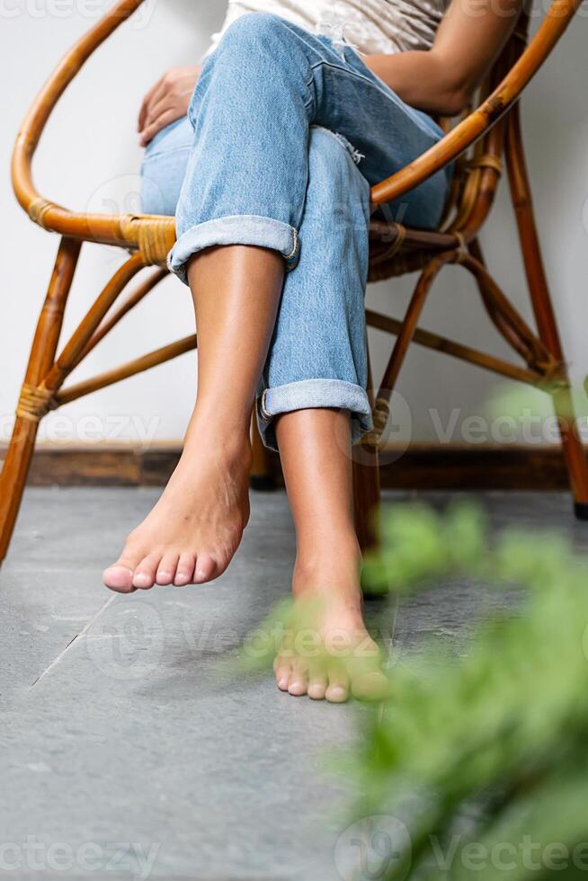 Woman sitting on wooden armchair on the balcony. photo