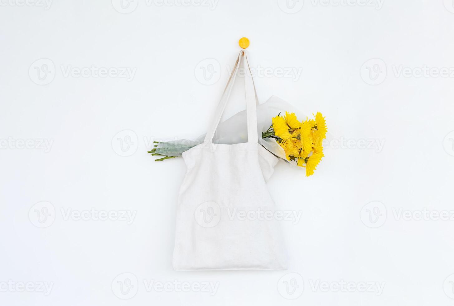 Blooms in reusable textile bag. Springtime burst of sunshine. photo