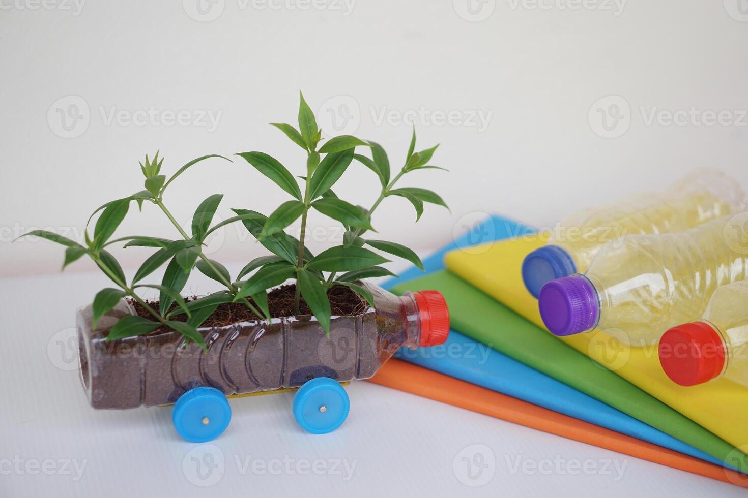 DIY car which grow plants, made from plastic bottle and caps.  Concept, Seedling from recycle crafts. Reduce, reuse and recycle plastic garbage photo