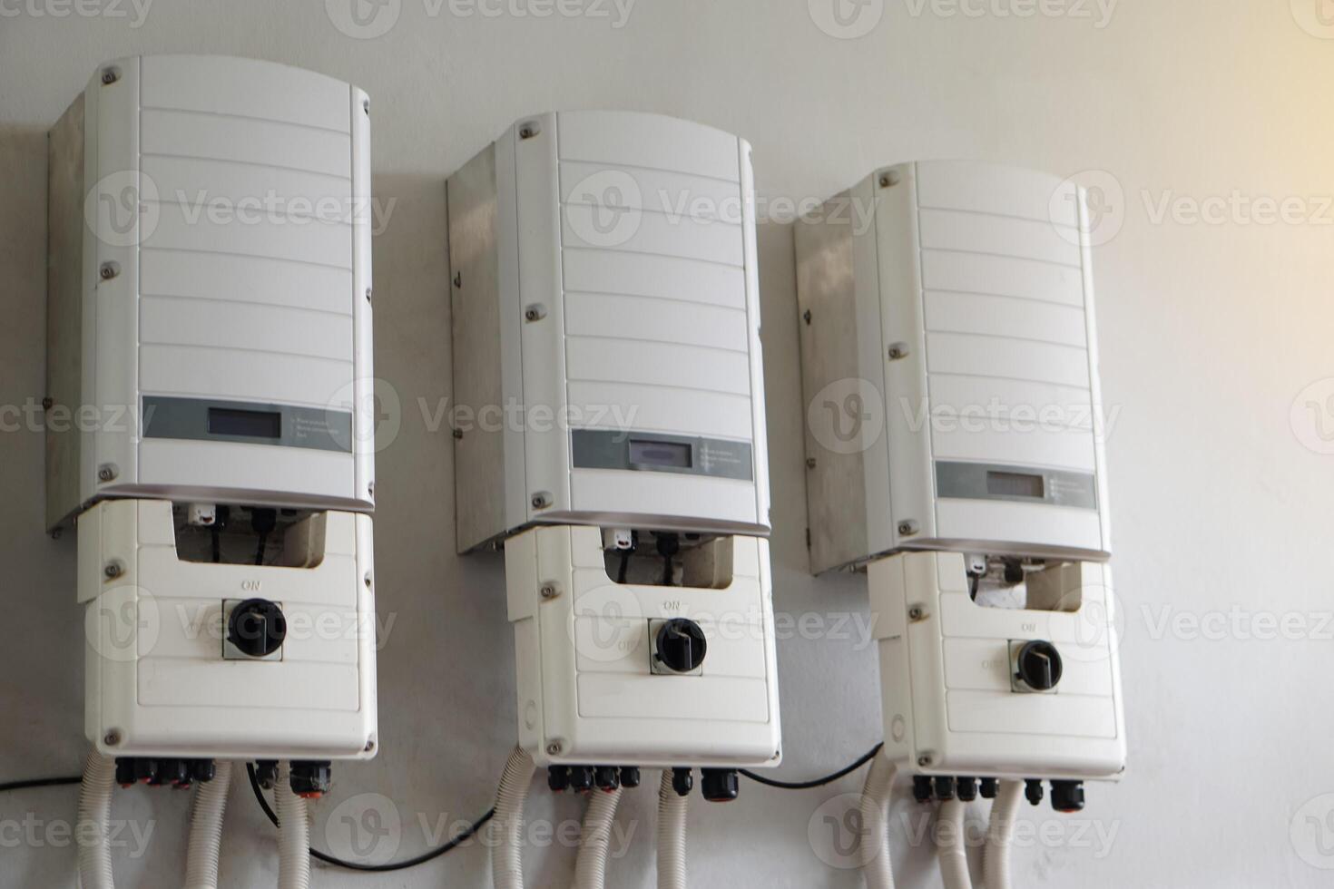 Photovoltaic power converter system unit installed on wall. Electrical converter converts direct current output of a photovoltaic  solar panel into alternating current . Solar cell technology. photo