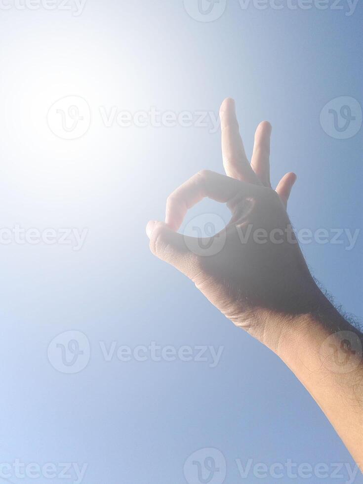 hand with blue sky photo