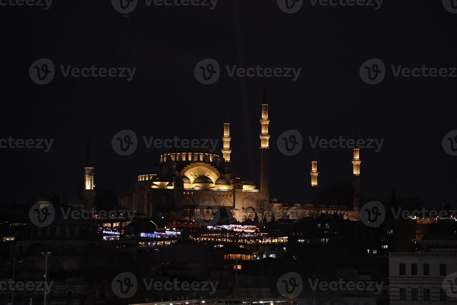 Suleymaniye Mosque Ottoman imperial in Istanbul, Turkey. It is the largest mosque in the city. Night view from Galata Bridge photo