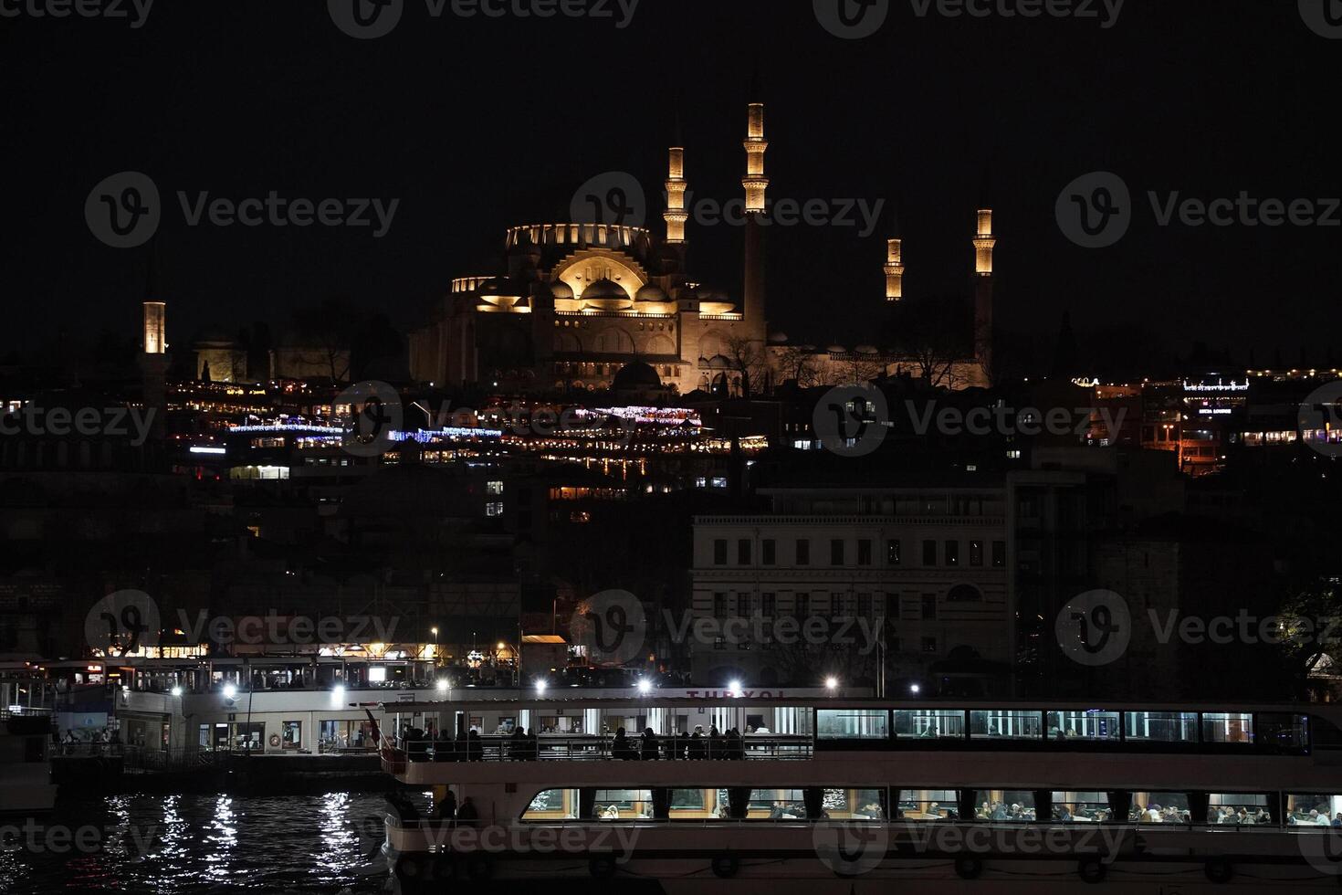 Suleymaniye Mosque Ottoman imperial in Istanbul, Turkey. It is the largest mosque in the city. Night view from Galata Bridge photo