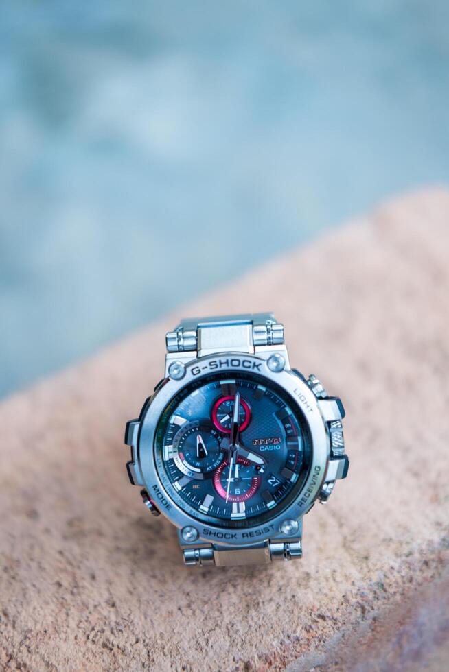 BANGKOK, THAILAND - FEBRUARY 5, 2024 G-Shock model MTG-B1000D-1ADR, stainless steel wristwatch. G-Shock is a line of watches manufactured by Casio. photo