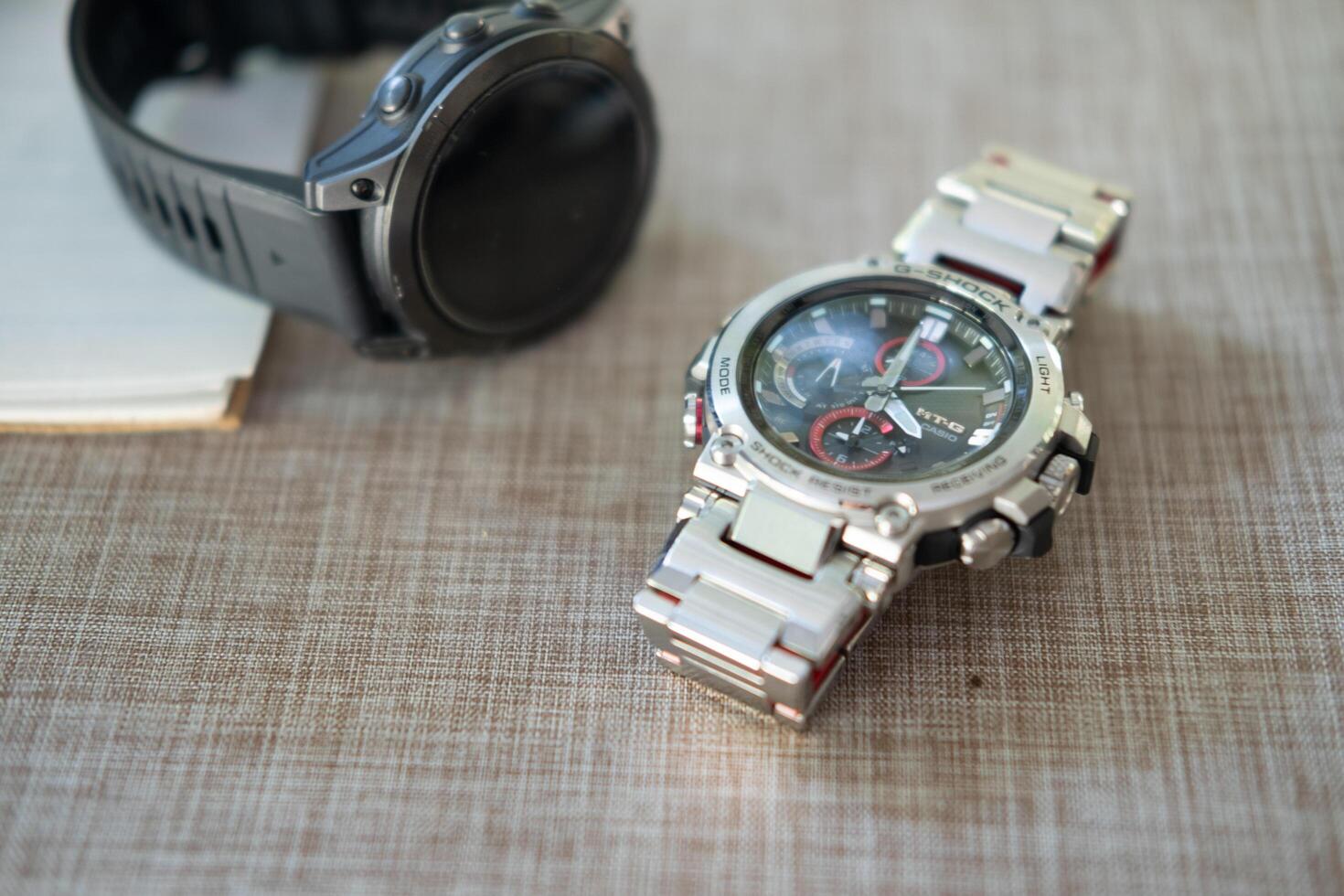 BANGKOK, THAILAND - FEBRUARY 5, 2024 G-Shock model MTG-B1000D-1ADR, stainless steel wristwatch. G-Shock is a line of watches manufactured by Casio. photo