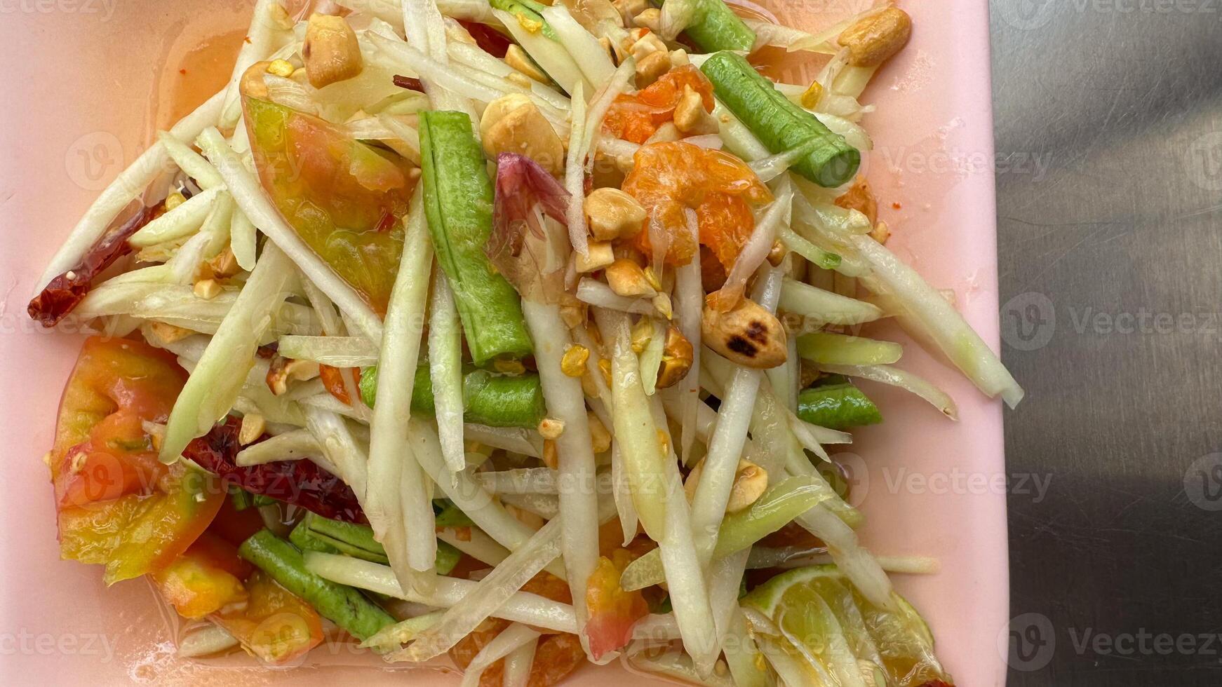 Papaya salad yummy or somtum is a spicy Thai food photo