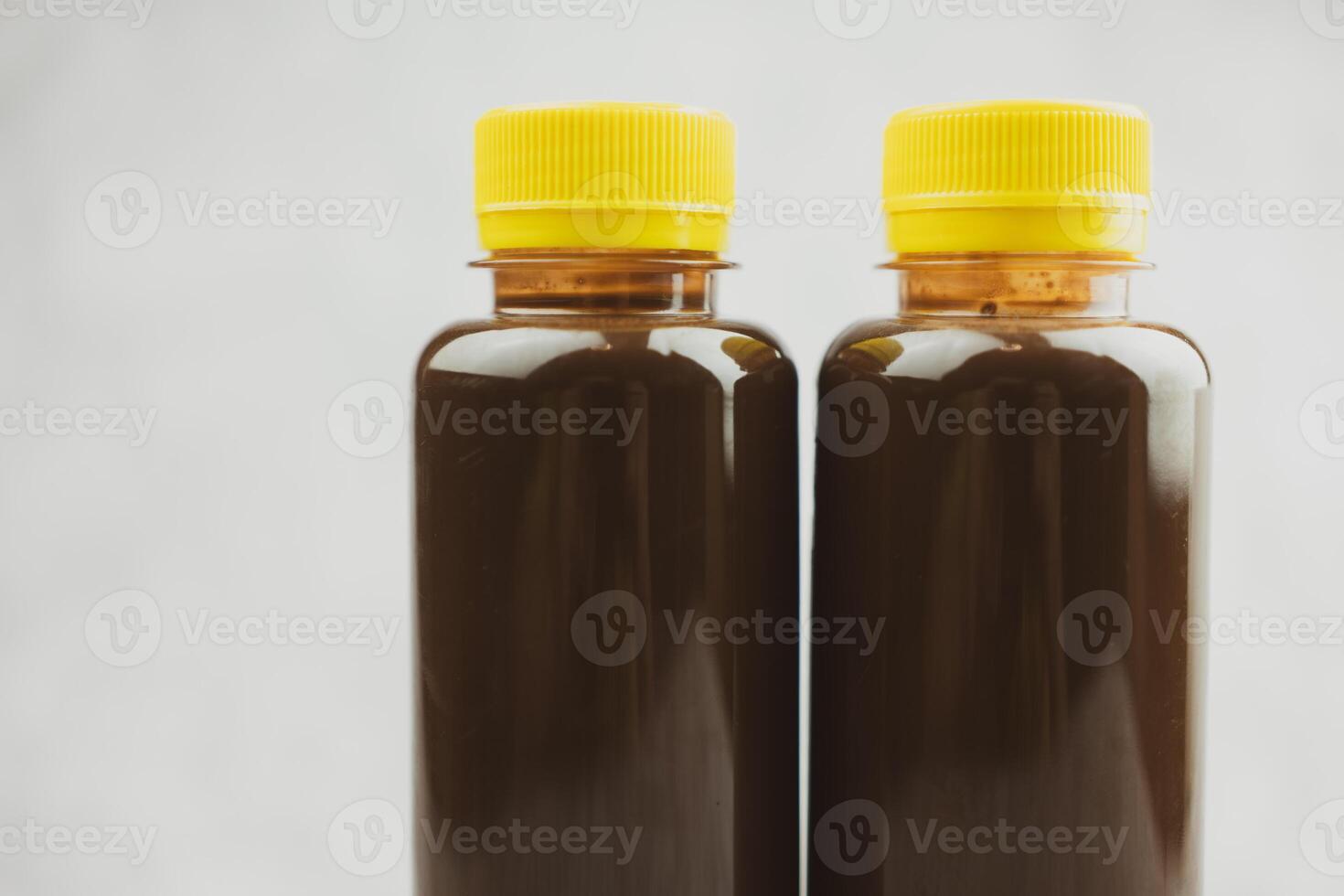 Transparent bottle of chocolate milk or cocoa milk in transparent bottle with yellow lid. photo