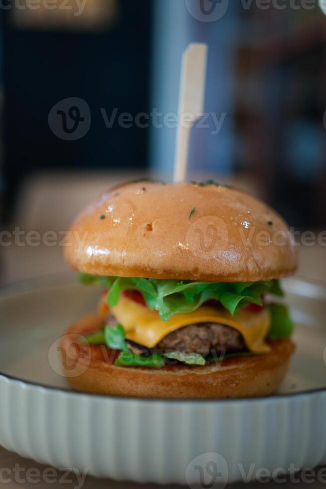 Delicious cheeseburger with pork and vegetable in bun photo