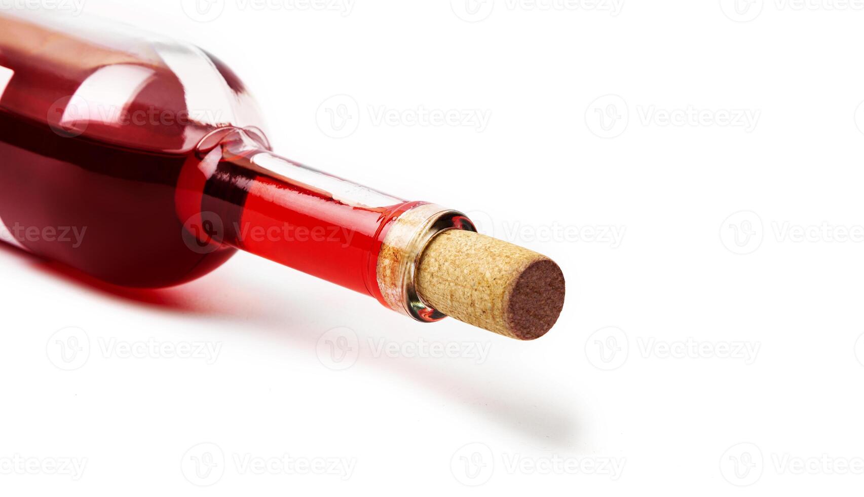 Closeup of a red wine bottle on a white background. photo