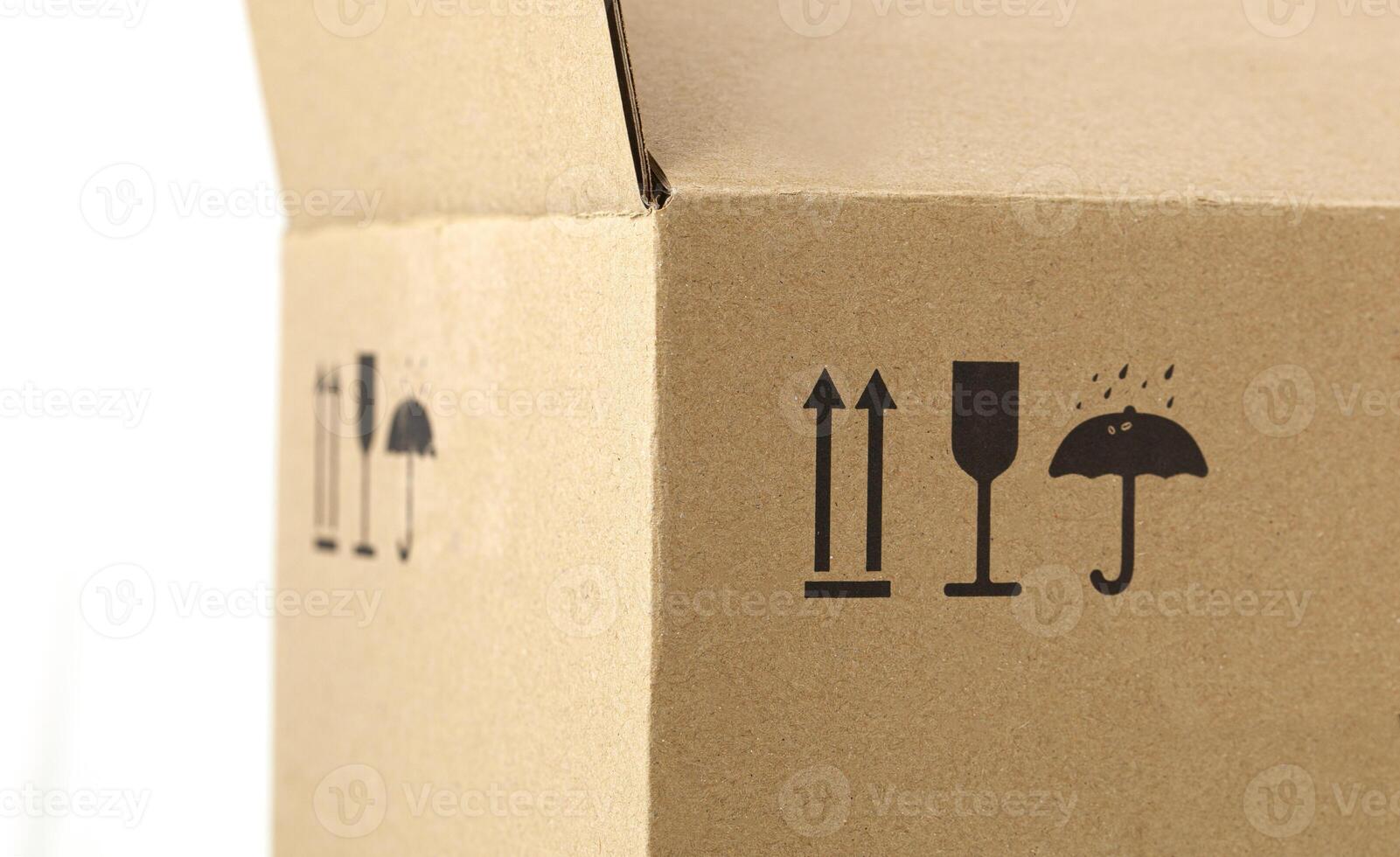 Closeup of a box made with recycled materials with recycling symbols photo