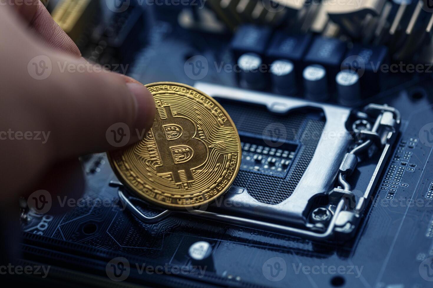 Bitcoin over computer motherboard, top view photo