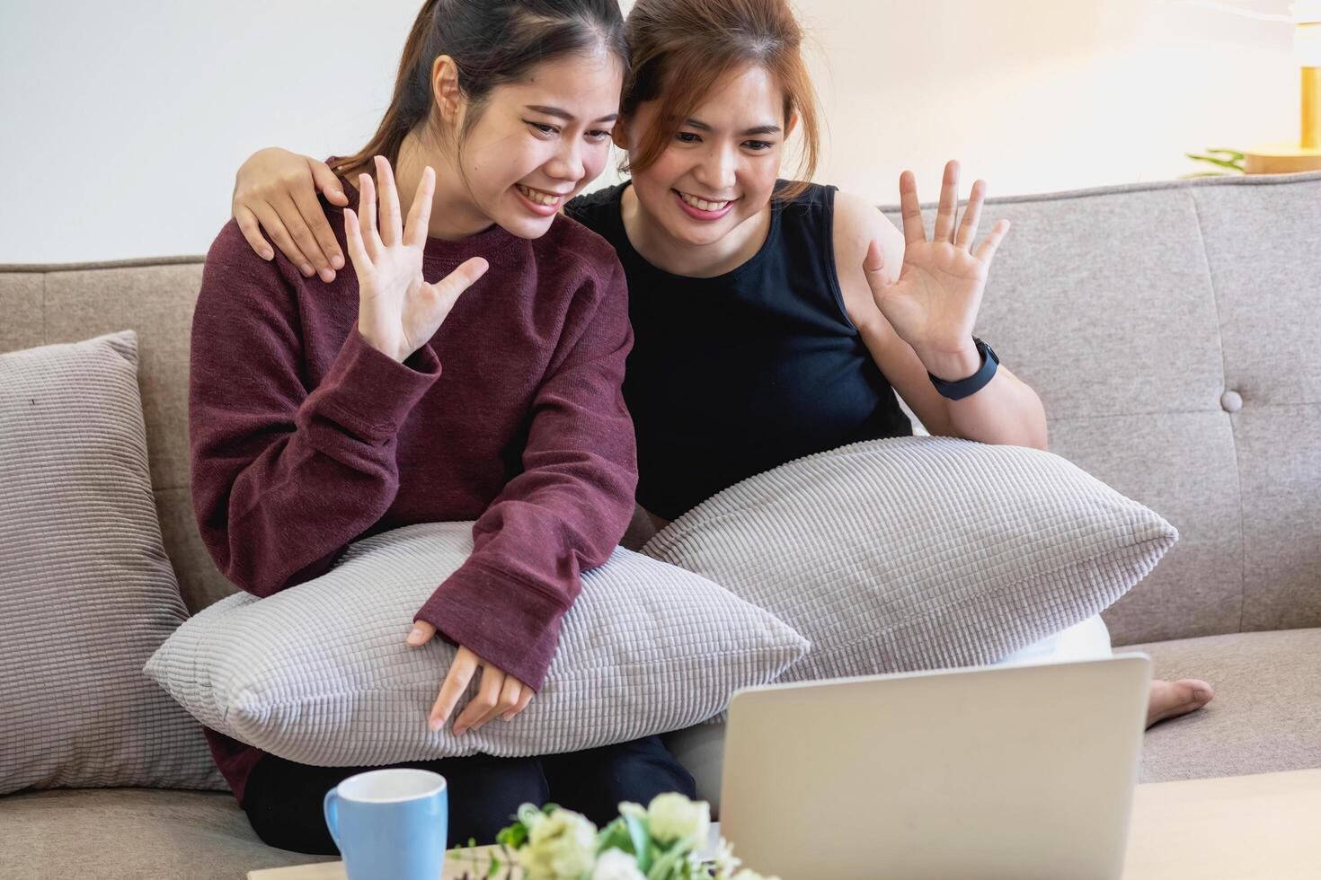 Relaxed young Asian woman enjoying relaxation on a comfy sofa at home. The beautiful girl calmly relaxes and breathes fresh air in the house. Watch movies and social networks. photo