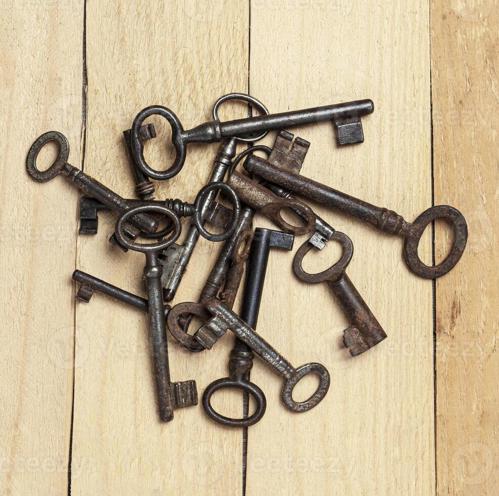 old keys on a background of wooden boards photo