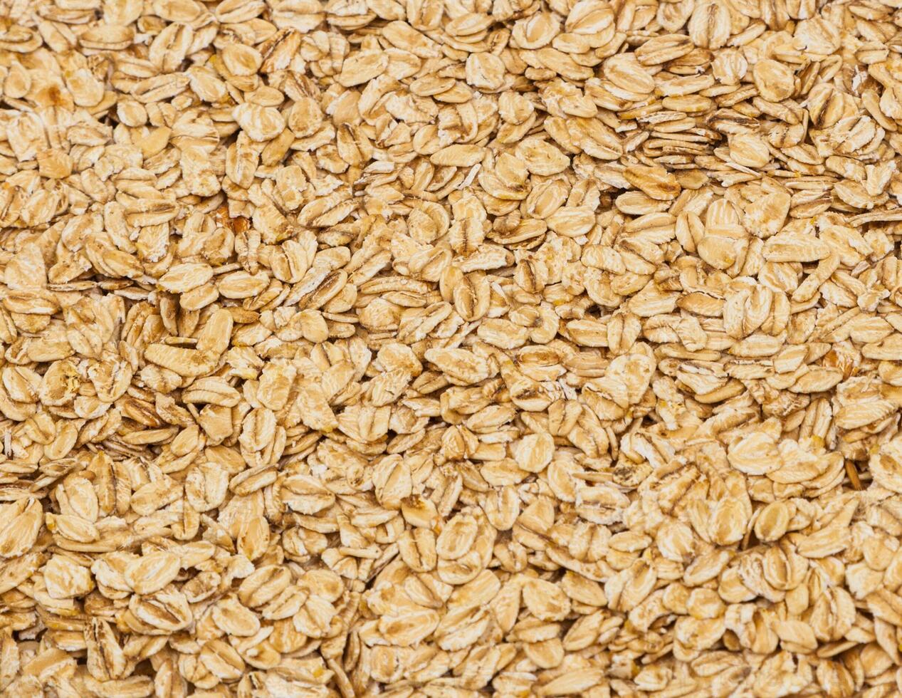 Surface coated with oatmeal flakes as a backdrop texture composition photo