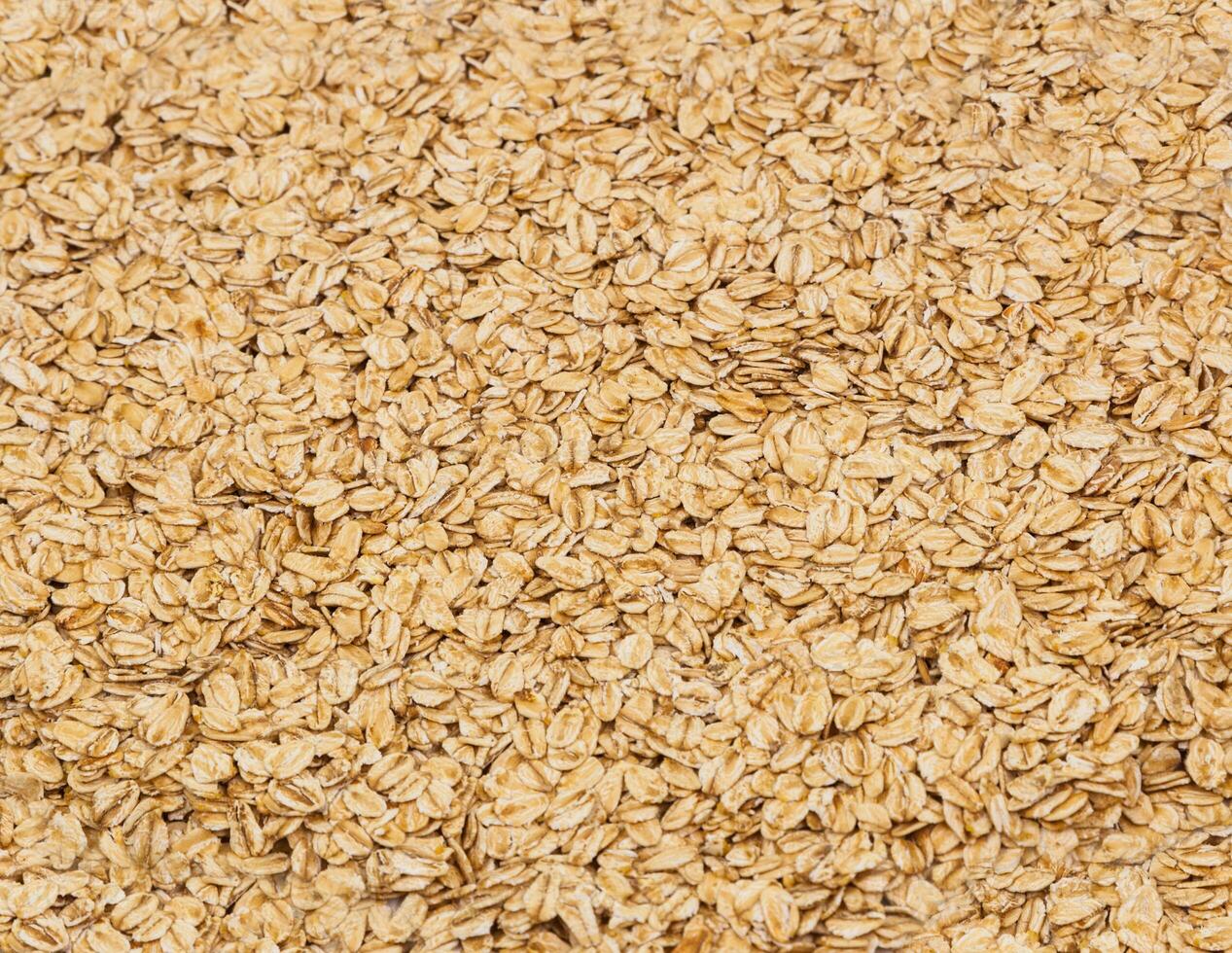 Surface coated with oatmeal flakes as a backdrop texture composi photo