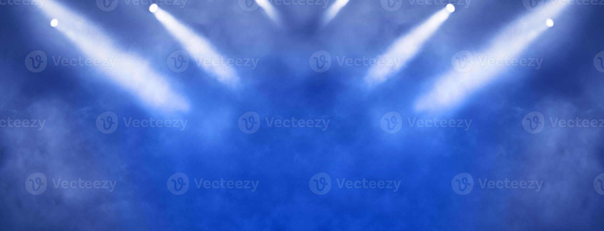 Stage light projector and glitter lights on blue background. photo