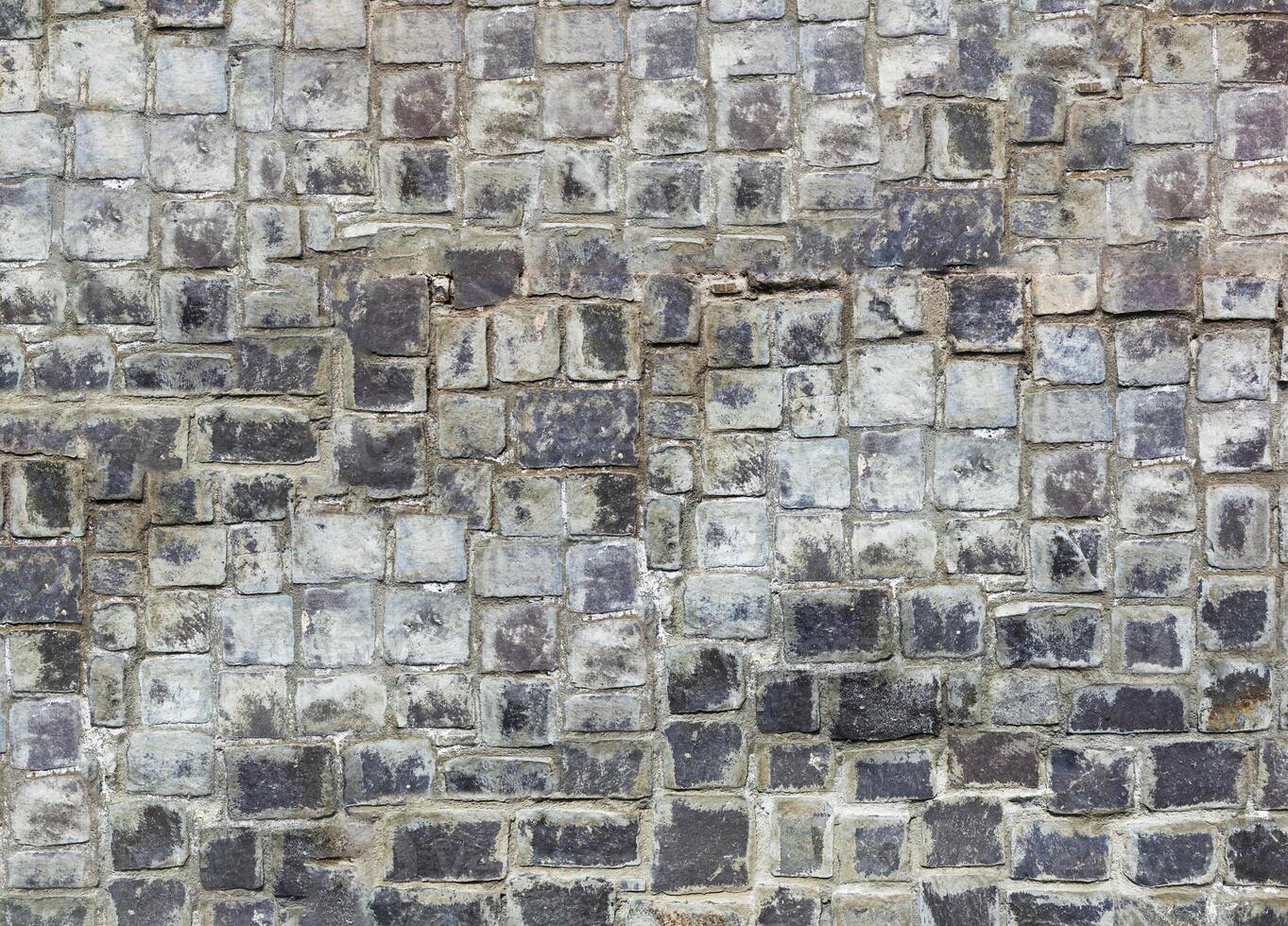 Natural stonewall, old stones in different sizes photo