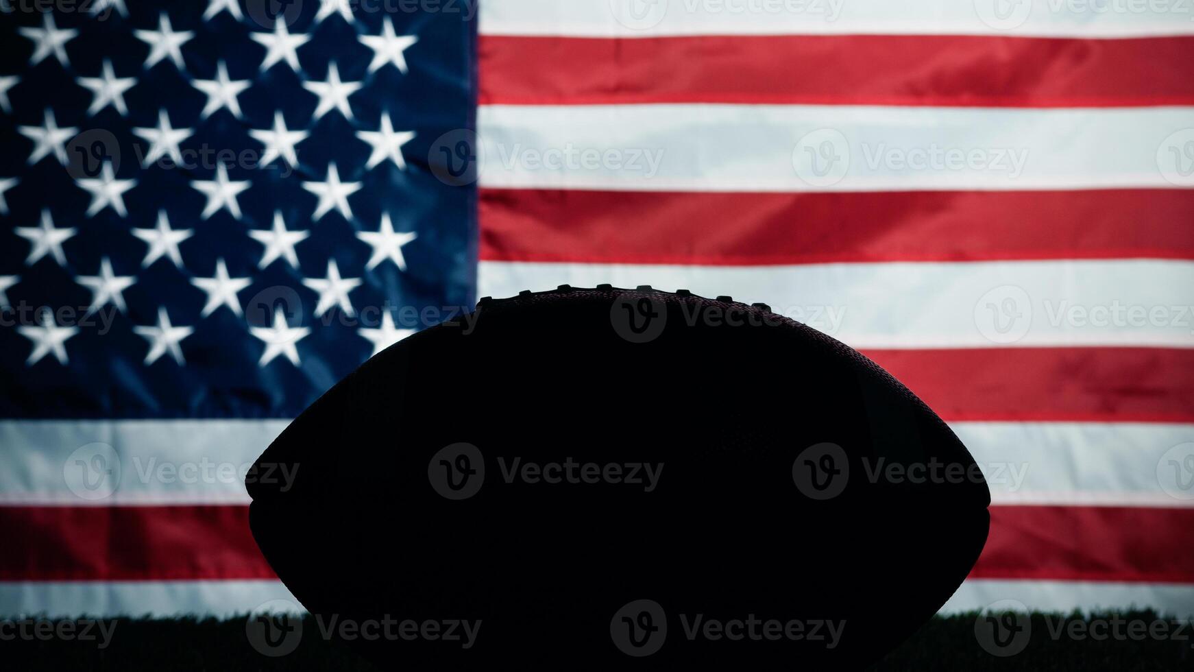 Silhouette of American football ball against usa flag photo