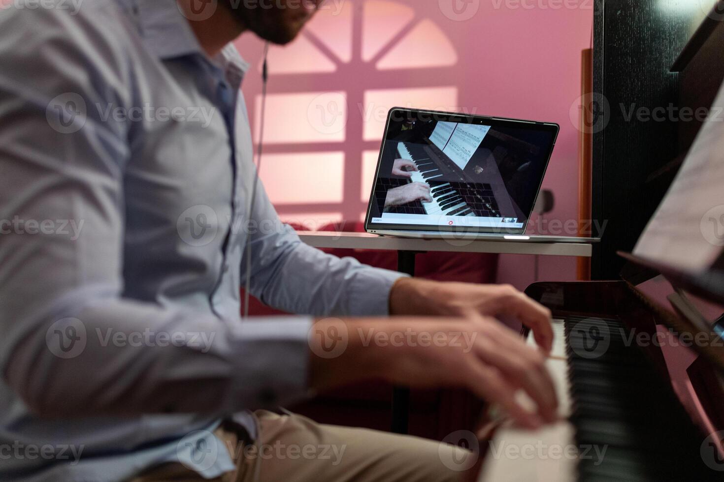 Man Teaching Piano Music Tutorial With Remote Video Streaming photo