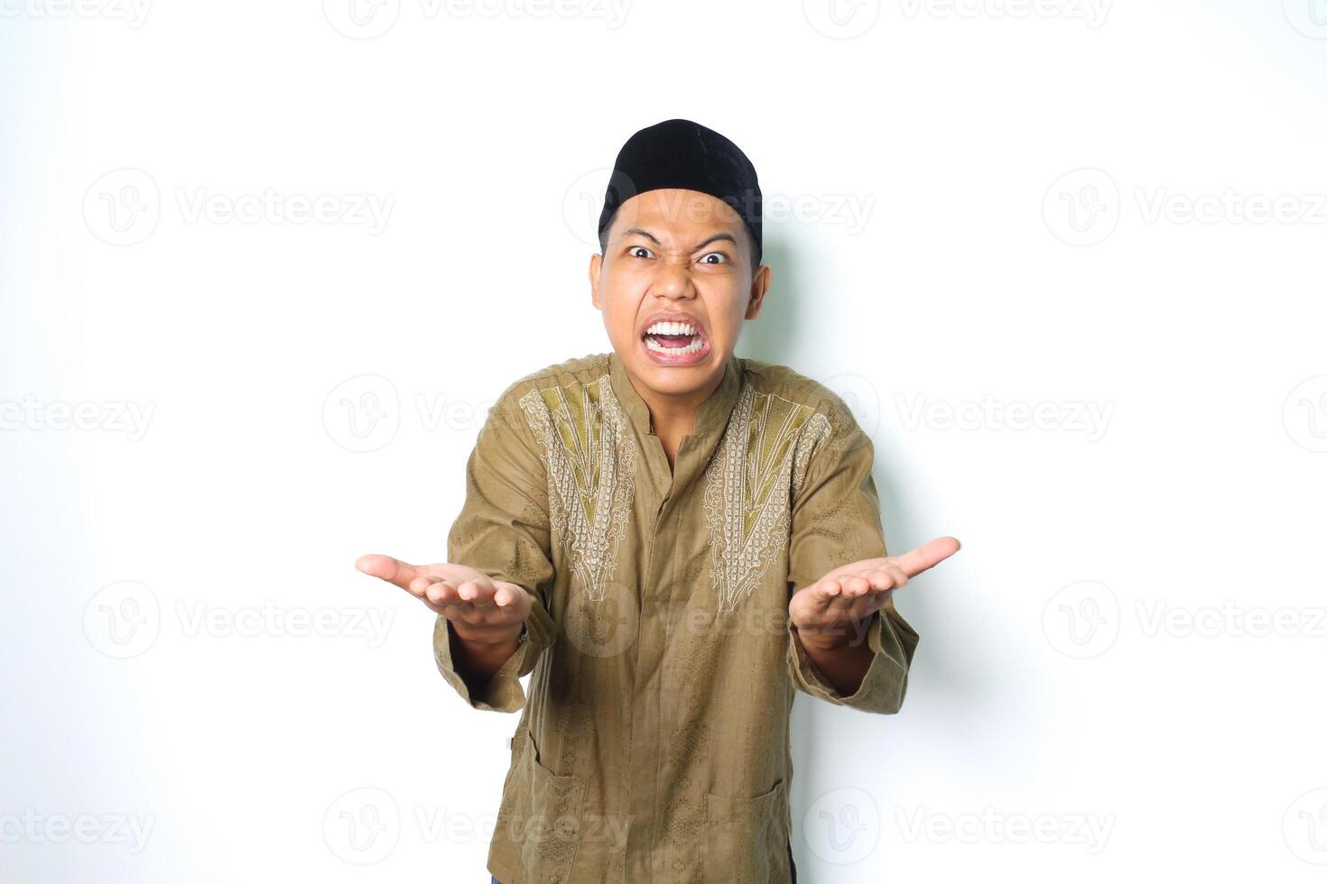 mad asian man wearing arabic clothes raising open palm gesturing how about this looking at camera isolated on white background photo