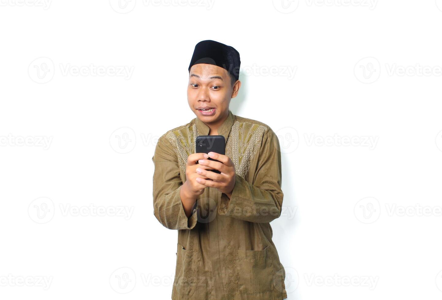 funny asian muslim man using smartphone isolated on white background photo