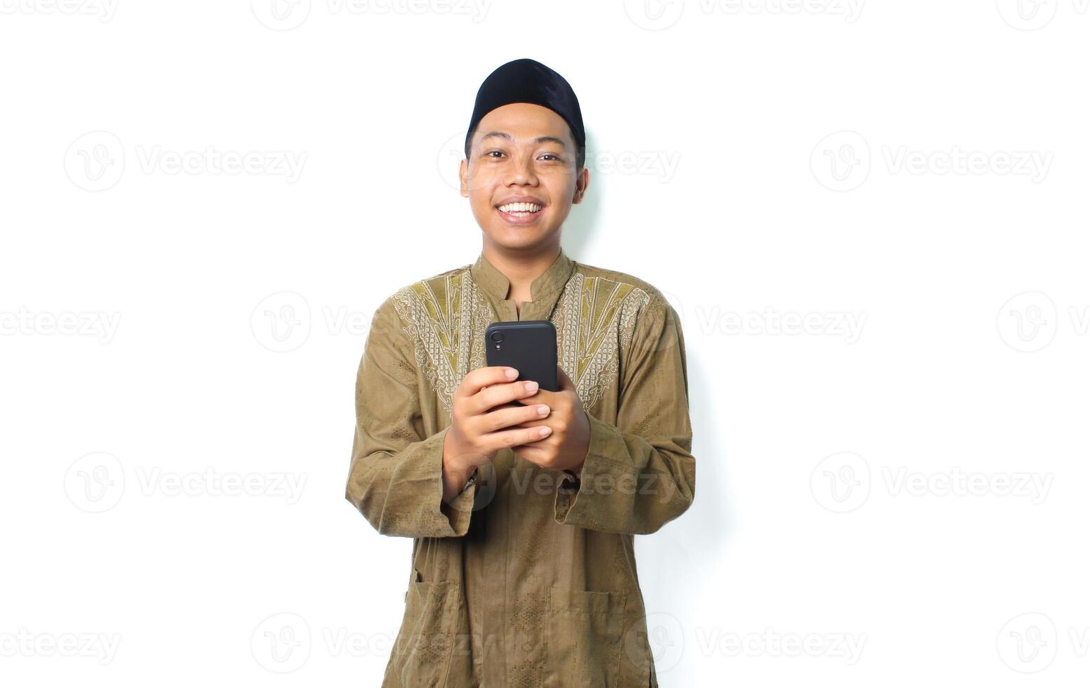 happy asian muslim man send message using mobile phone isolated on white background photo