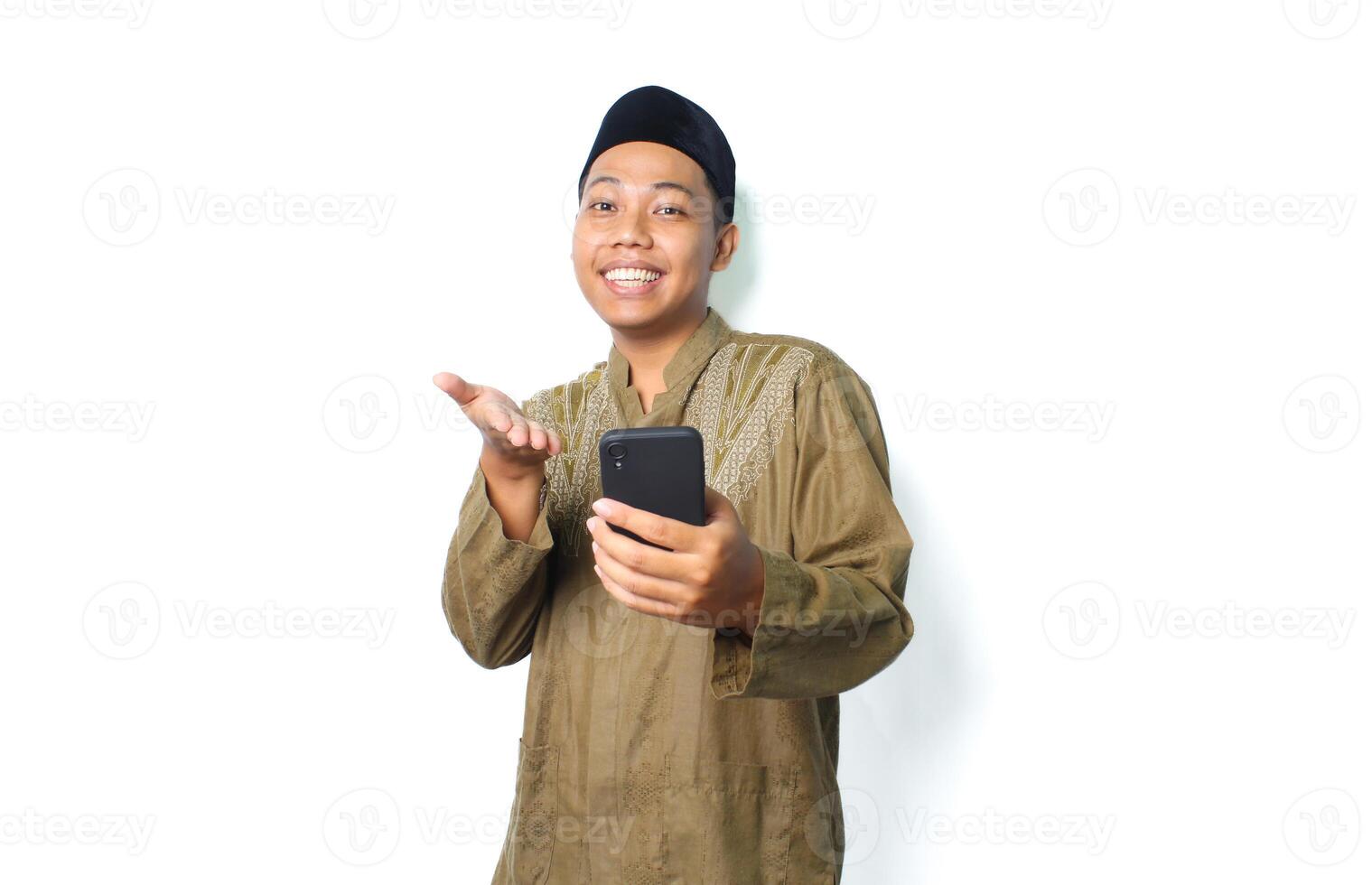 excited asian muslim man presenting application using mobile phone isolated on white background photo