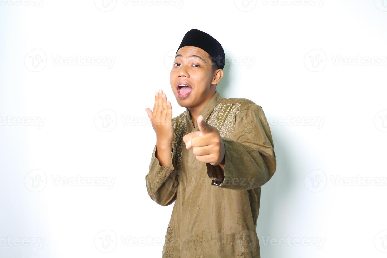 shocked asian muslim man pointing at camera with covering open mouth isolated on white background photo