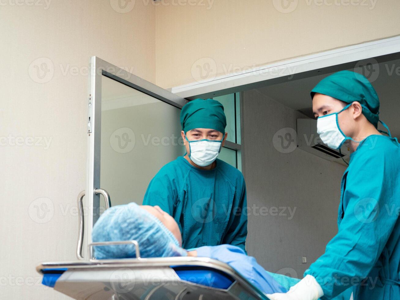 Hospital clinic operation room indoor doctor nurse staff assistance person people human Strolling a patient's bed doctor nurse staff assistance wear uniform mask bed health corridor emergency support photo