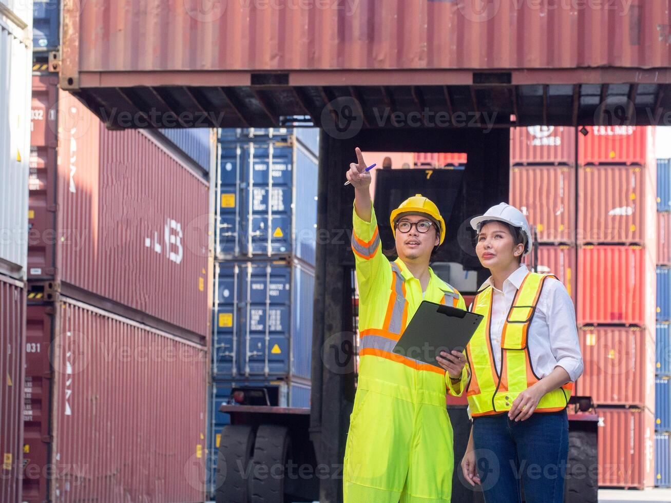 Crane forklift cargo container box good import export manager supervisor director pointing finger cheerful yellow white hardhat helmet safety engineer import export warehouse business logistic report photo