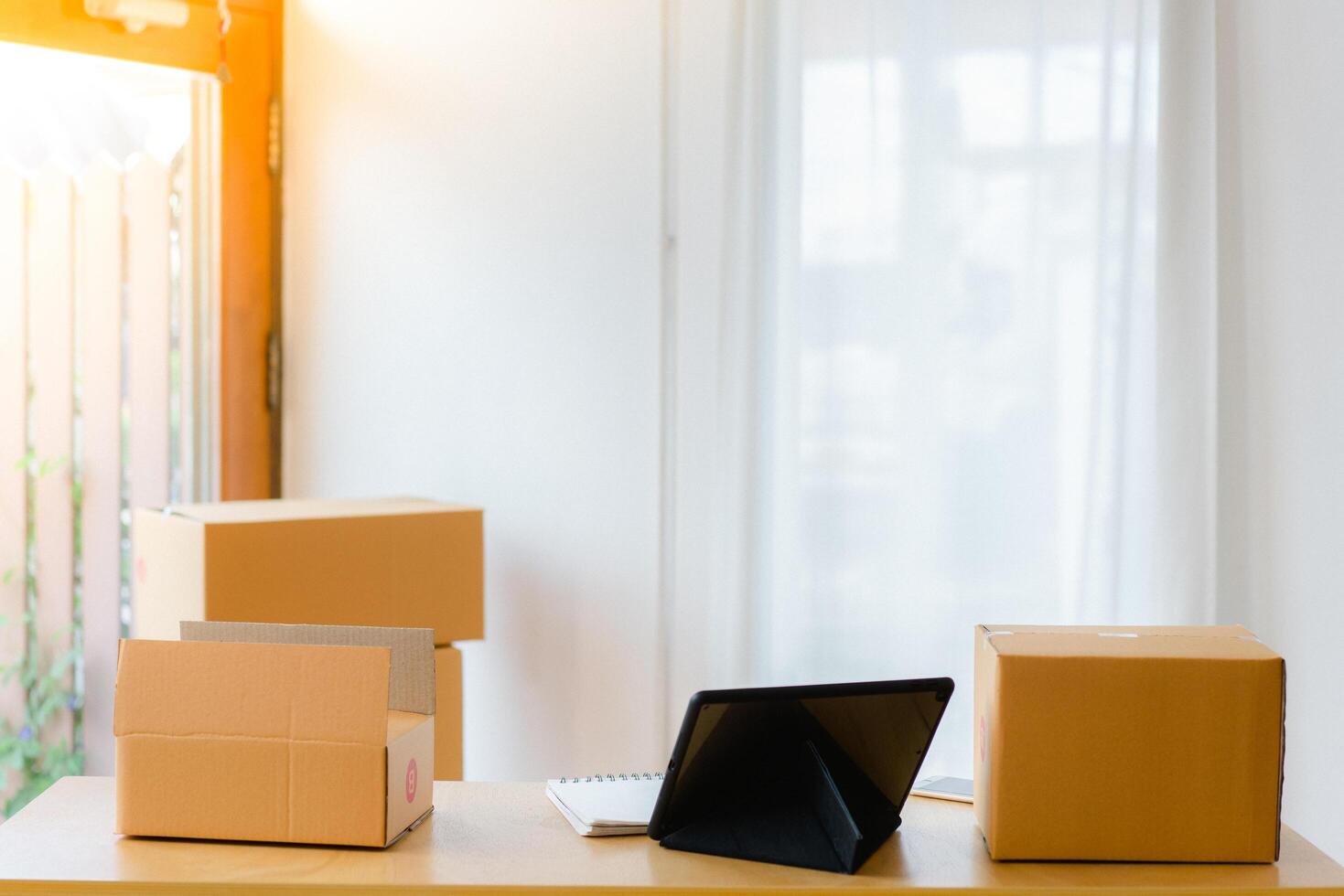 Portrait of Asian man packing box and check list in the office business , SME internet work from home business . photo